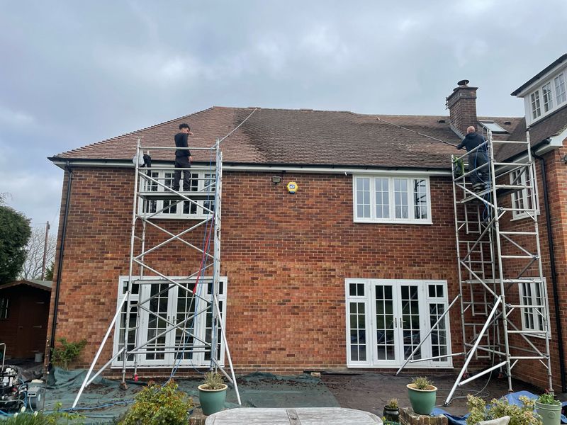 Roof cleaning carried out safely from scaffold towers by The Roof Moss Cleaners in Long Lawford